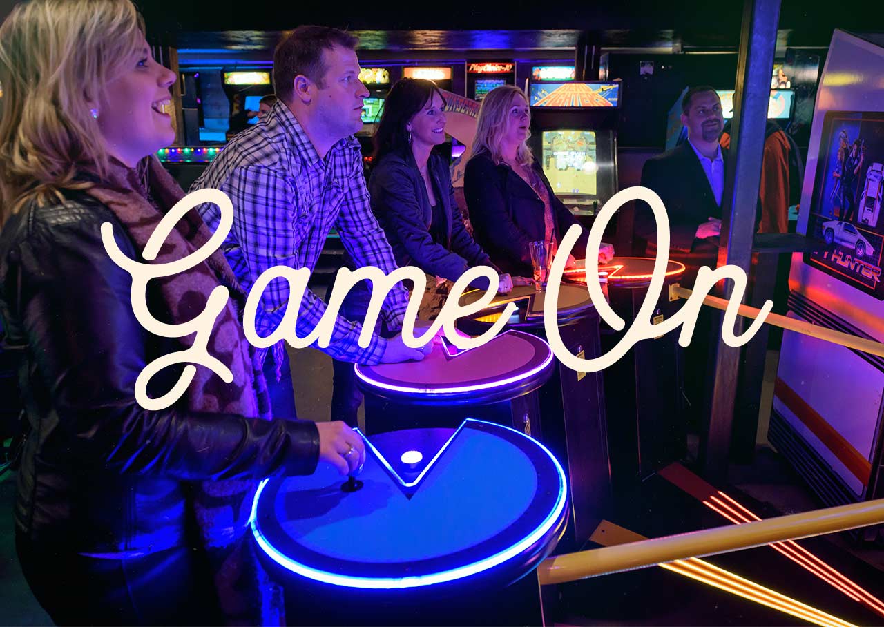 Game On! - People playing in an arcade.