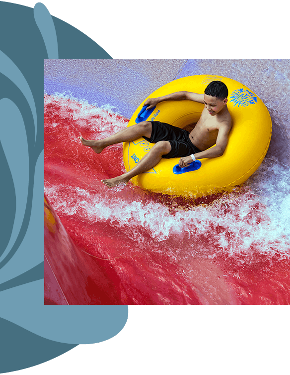 A boy going down a water slide.