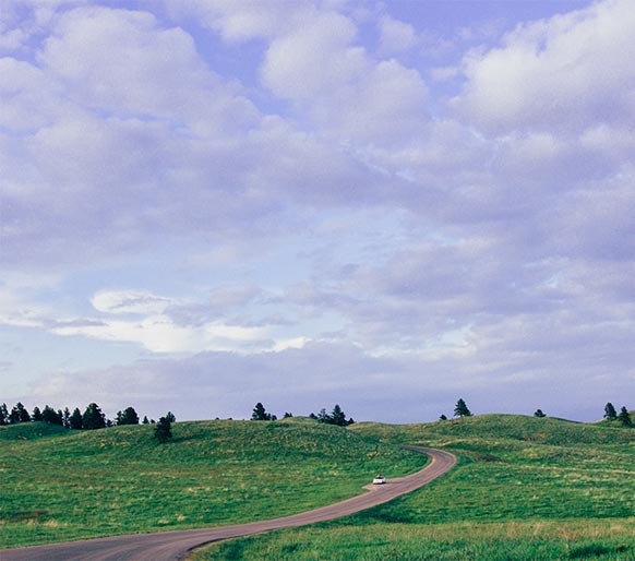 A car driving along a scenic road